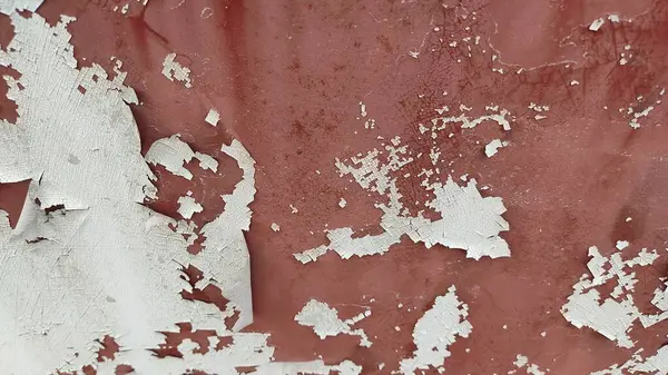 texture of a metal wall with scratches and cracks which can be used as a background. a lot of white and red.