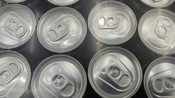 a bunch of aluminum cans with lids