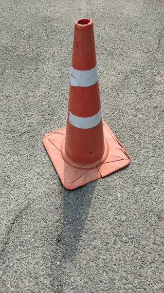 asphalt road with traffic cone