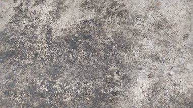 Çatlakları ve çizikleri olan beton bir duvarın dokusu arka plan olarak kullanılabilir.