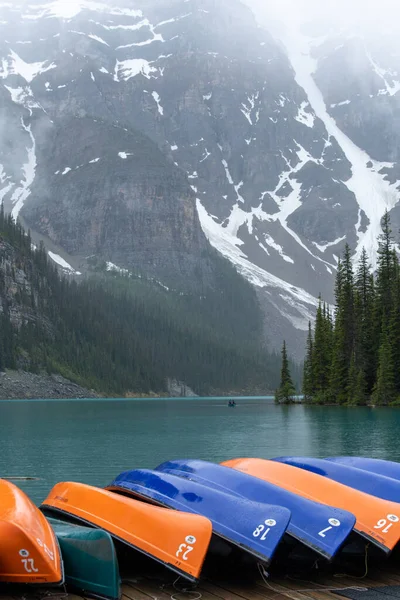 stock image Canoes in turquoise Lake Louise with snowy mountains in the background