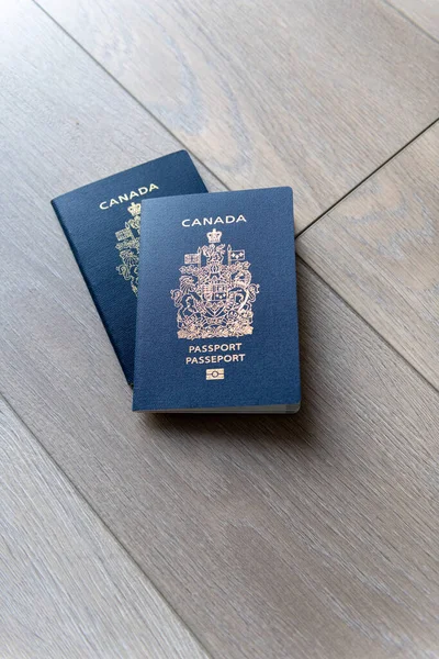 stock image Two Canadian passports on a neutral beige background