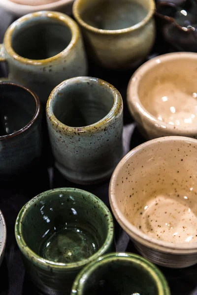 stock image Top view flay lay composition of table full of different colours shapes and sizes handmade speckled pottery ceramics cups bowls