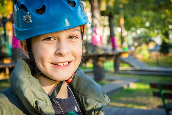 stock image A girl in belay climbs the cable car in the park.