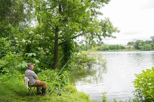 Summer Adult Man Sits River Catches Fish — Stock Photo, Image