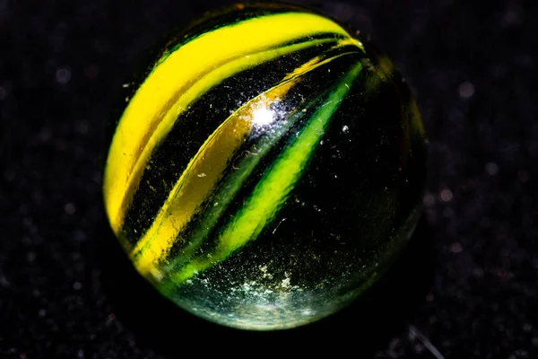 stock image close up of a green glass with black ball