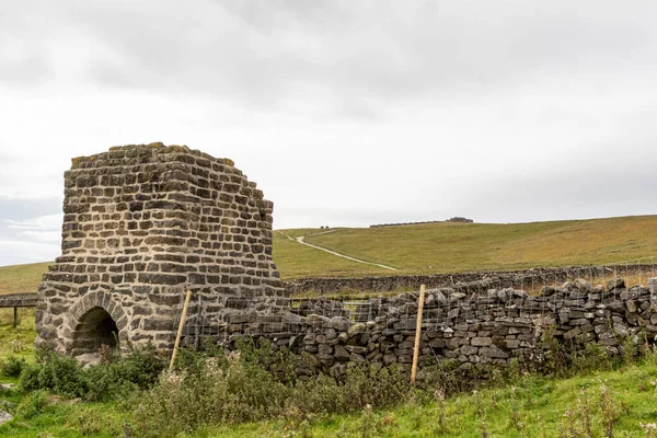 stock image a vertical shot of an old stone wall surrounded by a beautiful cloudy sky