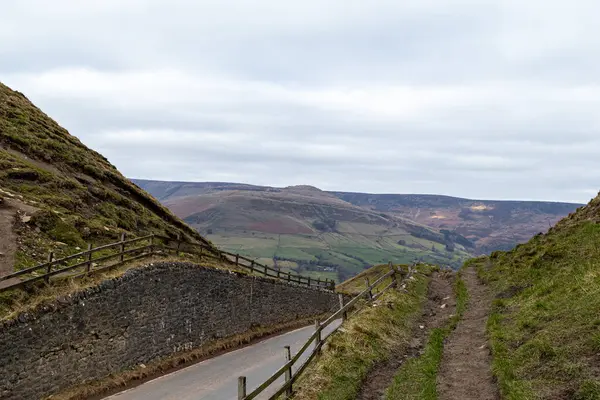 stock image the road leading to the top of the hills of the valley of the national park in the uk