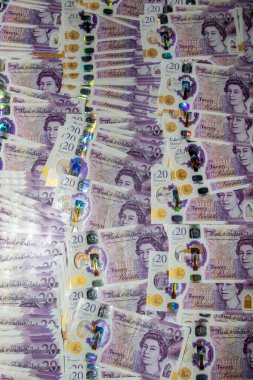 Daire şeklinde düzenlenmiş büyük bir İngiliz 20 poundluk banknotları. Notlarda Kraliçe II. Elizabeth 'in portresi ve hologramlar ve filigranlar gibi çeşitli güvenlik özellikleri yer alıyor. Canlı renklerini ve karmaşık tasarımlarını sergiliyorlar..