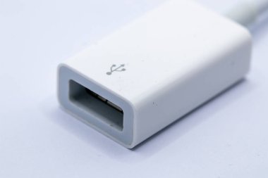 Close-up of a white USB adapter, angled to show both the USB-A and USB-B connectors.  The adapter shows minor surface wear. clipart