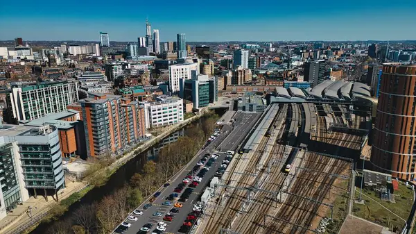 Leeds, İngiltere 'de açık bir günde tren rayları, nehir, binalar ve otopark manzaralı bir şehir..