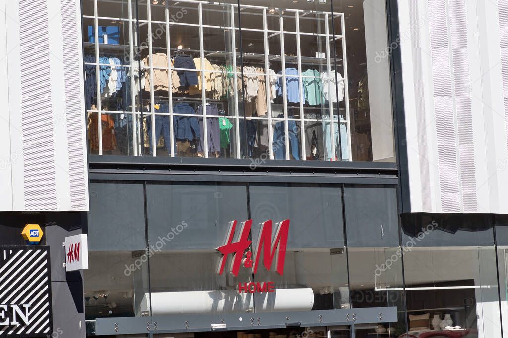 Exterior view of an H&M store front with clothing displayed in the window and the store logo prominently featured in Liverpool, UK.