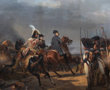 Painting depicts Napoleon on horseback, accompanied by officers, observing infantry lines in a battlefield scene with a dark, overcast sky at Versailles Palace, Paris.