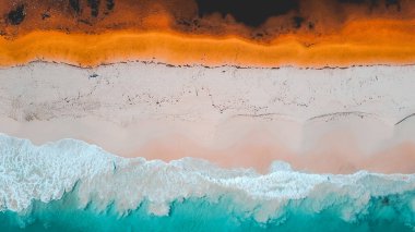 Aerial view of where the river meets the sea. Vibrant orange and dark river meet turquoise sea waves on beach in Western Australian town called Guilderton. Seascape background. Coastal wallpaper. clipart