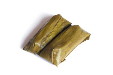 Lontong beyaz arka planda izole edildi. Lontong muz yapraklarına sarılı pilavdır ve kaynar suyun üzerinde saatlerce buharla pişirilir. Lontong, Ramazan ve Ramazan aylarında popüler bir yemektir.