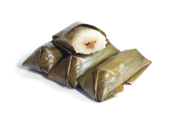 stock image Lontong isolated on white background. Lontong is rice wrapped in banana leaves and steamed over boiling water for several hours. Lontong is a popular food during Ramadan and Eid al-Fitr