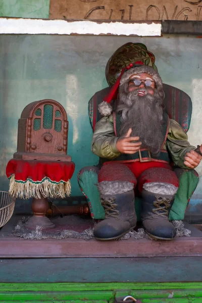 Stock image Used Santa Claus doll on display at a flea market