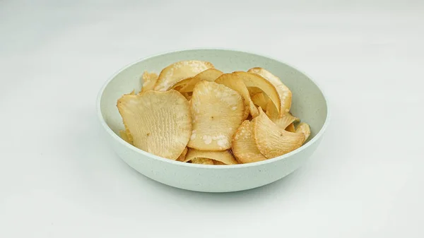 stock image Pile of healthy sweet potato chips in a bowl isolated on a white background.