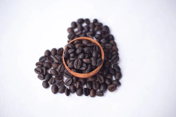 stock image coffee beans on a wooden bowl with love shape