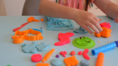 Renkli kil. Çocuk elleri renkli kille oynuyor. Plastiksin. Hamur oyna.