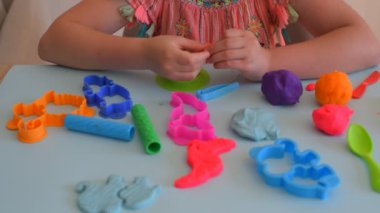 Renkli kil. Çocuk elleri renkli kille oynuyor. Plastiksin. Hamur oyna.