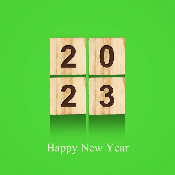 2023. Numbers on wooden blocks, on a bright green background. Holidays. Background.