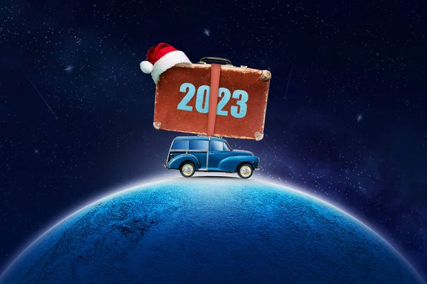 Car with a suitcase on the roof, 2023, in Santa's hat. On the planet in the cosmic, starry sky. Copy space. New Year card. Festive background.