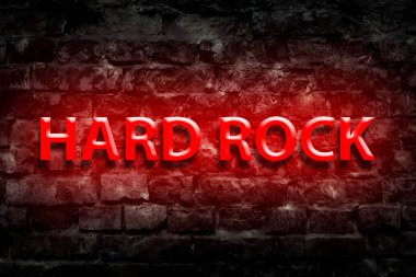 Hard Rock. Neon işareti. Eski, antika tuğlaların duvarında. Müzikte yön. Müzikal stil. Tasarım ögesi.