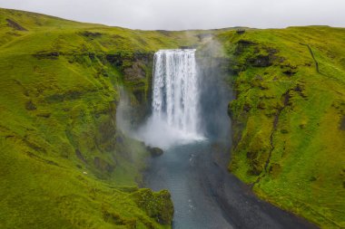 Iceland. Aerial view on the Skogafoss waterfall. Landscape in the Iceland from air. Famous place in Iceland. Landscape from drone. Travel concept. clipart