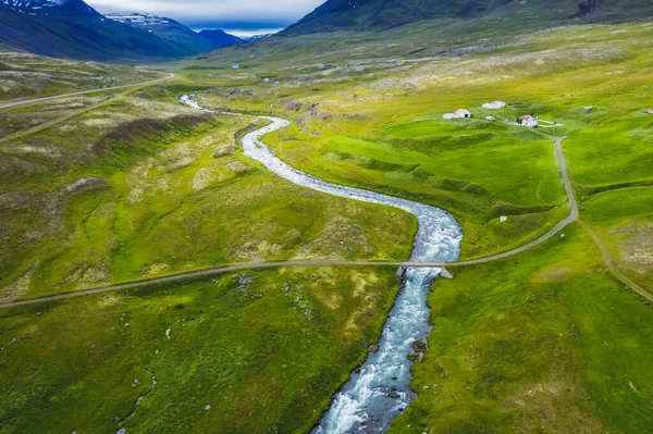 stock image Iceland. Aerial view of road and small bridge over blue mountain river. Aerial scenic view of Iceland landscape. Travel vacation concept.