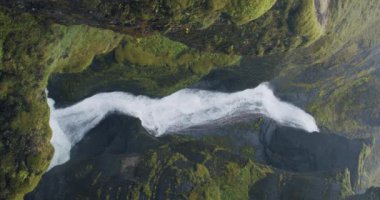Fjadrargljufur canyon Waterfall between bizarre steep cliff rock formations Iceland, Europe.