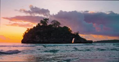 Amazing sunrise over ocean tropical beach. Yellow dramatic colorful cloudy sky. Orange colors waves. Nature background. Beautiful serene scene. Morning. Sunlight reflect on water surface