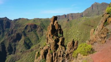High volcanic green mountains form a huge gorge in Teno national park Masca village. Hiking area. Tourist attraction. Aerial cinematic flight. Tenerife Canary Islands Spain Europe. Reserve.