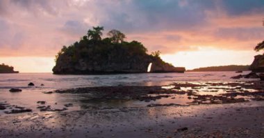 Static view of ocean from the shore. Small tropical Island with Idyllic lagoon at colorful sunset. Crystal Bay Beach in Nusa Penida Indonesia. Nobody. Sandy coastline.