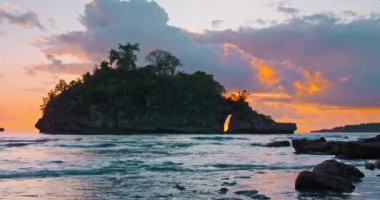 Static view of ocean from the shore. Small tropical Island with Idyllic lagoon at colorful sunset. Crystal Bay Beach in Nusa Penida Indonesia. Nobody. Sandy coastline.