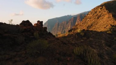 Sunset at the Los Gigantes Cliffs with deep ocean view Tenerife island, Canary, Spain. The Giants in Atlantic waters. Cinematic aerial flight. Nobody.