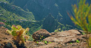 Beautiful view of the Masca Gorge or Barranco de Maska from the peak of the mountain peak. Rocky mountains in the foreground. Mirador La Cruz de Hilda. Nobody.