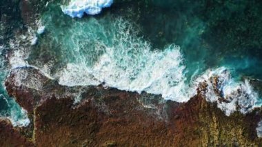 Pristine rocky volcanic barren coastline and turquoise ocean water with white foaming waves. Aerial top down static drone view. Tenerife Canary Islands. Nobody.