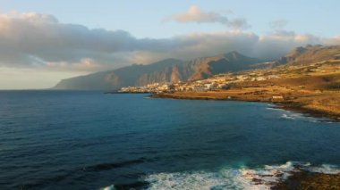 Ocean waves crash on rocky shore volcanic beach. Wild untouched environment. Pristine nature landscape. Tenerife Canary Islands Spain. Punta Juanita.