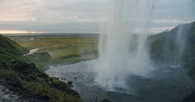 Close up of beautiful Seljalandfoss waterfall by sunset, Iceland