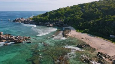 Gece ışığında granit kayalarla gözden uzak kumsalın insansız hava aracı görüntüsü. Seyşeller 'deki La Digue Adası