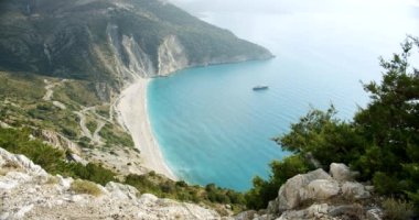 Yunanistan 'ın Kefalonia adasındaki ünlü Myrtos. Akşam güneşinde lüks yat..