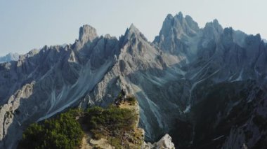 Dolomitler, İtalya. Uçurumun tepesindeki kadınların hava manzarası. Arka planda Cadini di Misurina dağlarının Auronzo di Cadore tepeleri var. Tre Cime di Levaredo Ulusal Parkı ve UNESCO Dünya Mirası Alanı.