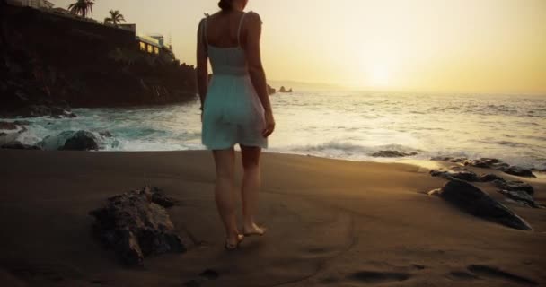 Barefoot Woman Silhouette Walks Black Sand Beach Sunset Raises Hands — Stock Video