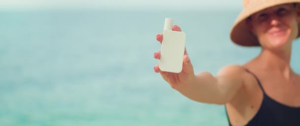 Woman Demonstrating White Tube Sunscreen Skin Care Cream Ocean Background — Stock Video