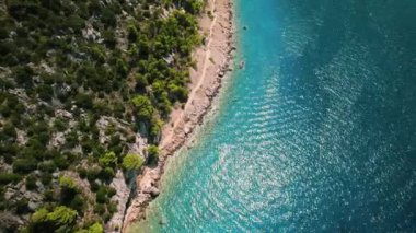 Makarska kıyı şeridinin havadan görüntüsü. Kristal sular çakıl taşlı kıyılara kenar. Çakıl taşı plajları ve kristal berrak sularla çevrili sakin Adriyatik 'e doğru inen Biokovo dağlık yamaçları.