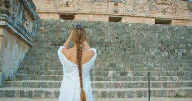 Meksika turu sırasında Maya harabelerinin antik basamaklı yapısını çeken kadın..