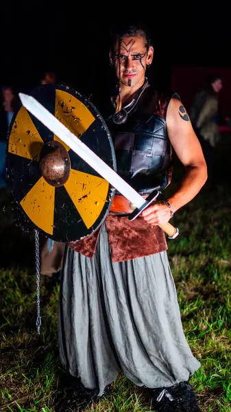 Viking warrior with black war paint, holding his axe.