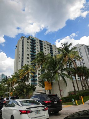 Miami, USA - April 24, 2022: Modern apartment buildings with palm trees at Avenue at Miami, Usa