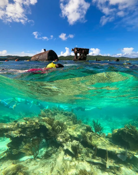 The people at snorkeling underwater and fishing tour by boat at the Caribbean Sea at St. Thomas, USVI in US Virgin Islands - travel concept